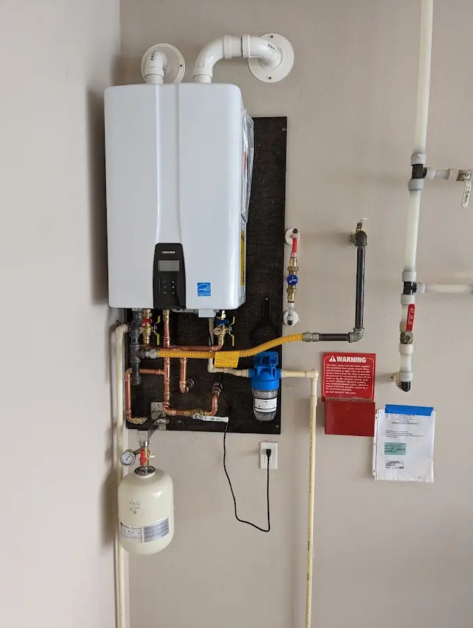 Professional plumber installing copper piping in a Clovis home